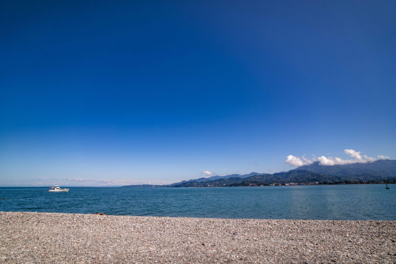 Scenery of black sea on a background of mountains in Batumi, Georgia on a sunny clear day