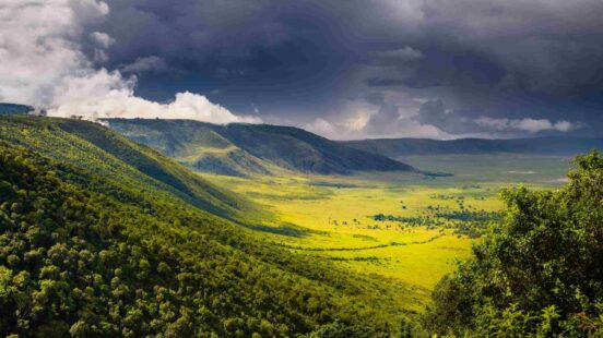 Clouds rolling in over the verdant hills of the Ngorongoro Crater, Tanzania.
