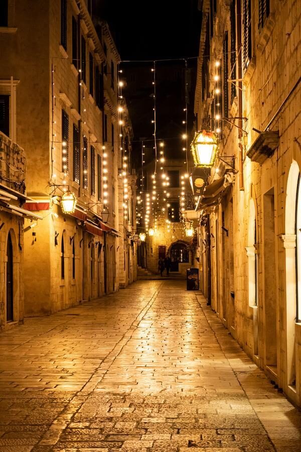 Empty Dubrovnik city streets during winter, decorated withchristmas lamps dubrovnik streets, stone street, dalmatia, croatia, famous town, medieval, old houses, paved road, christmas lights, street lamp, heritage, unesco world heritage site, famous, historical, amazing, tourist destination Dubrovnik, Croatia-January 5th, 2023: Empty Dubrovnik city streets during winter, decorated withchristmas lamps
