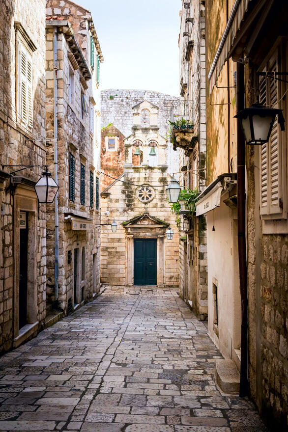 Narrow Street inside Dubrovnik Old Town adriatic, alley, ancient, antique, architecture, building, church, city, croatia, dalmatia, day, door, dubrovnik, eastern, entrance, europe, european, exterior, green, historic, history, holiday, home, house, italy, journey, landscape, medieval, mediterranean, narrow, nobody, old, path, pavement, roof, staircase, stairway, steps, stone, street, summer, tourism, tourist, town, travel, tree, urban, vacation, wall, window Dubrovnik, Croatia From Adobe Stock