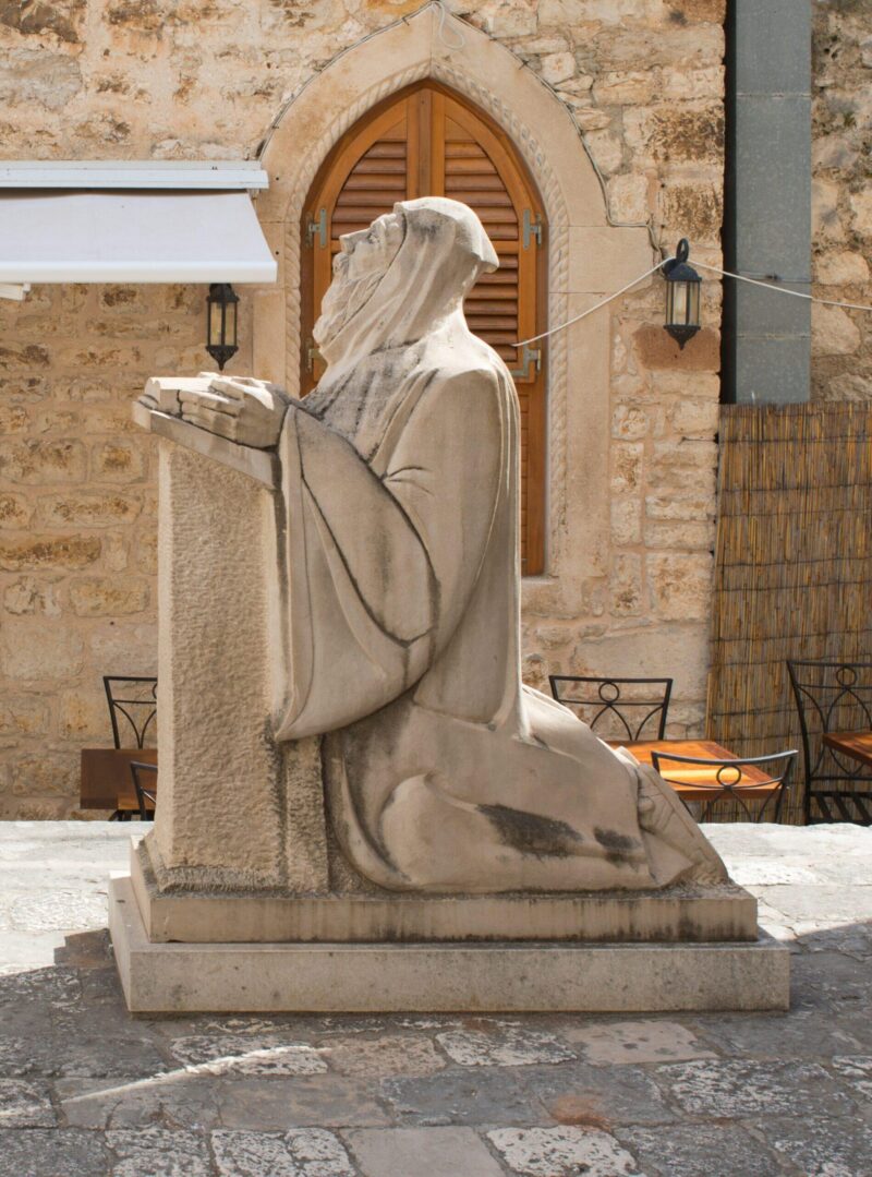Statue of praying monk in Hvor town on Hvar island, Croatia