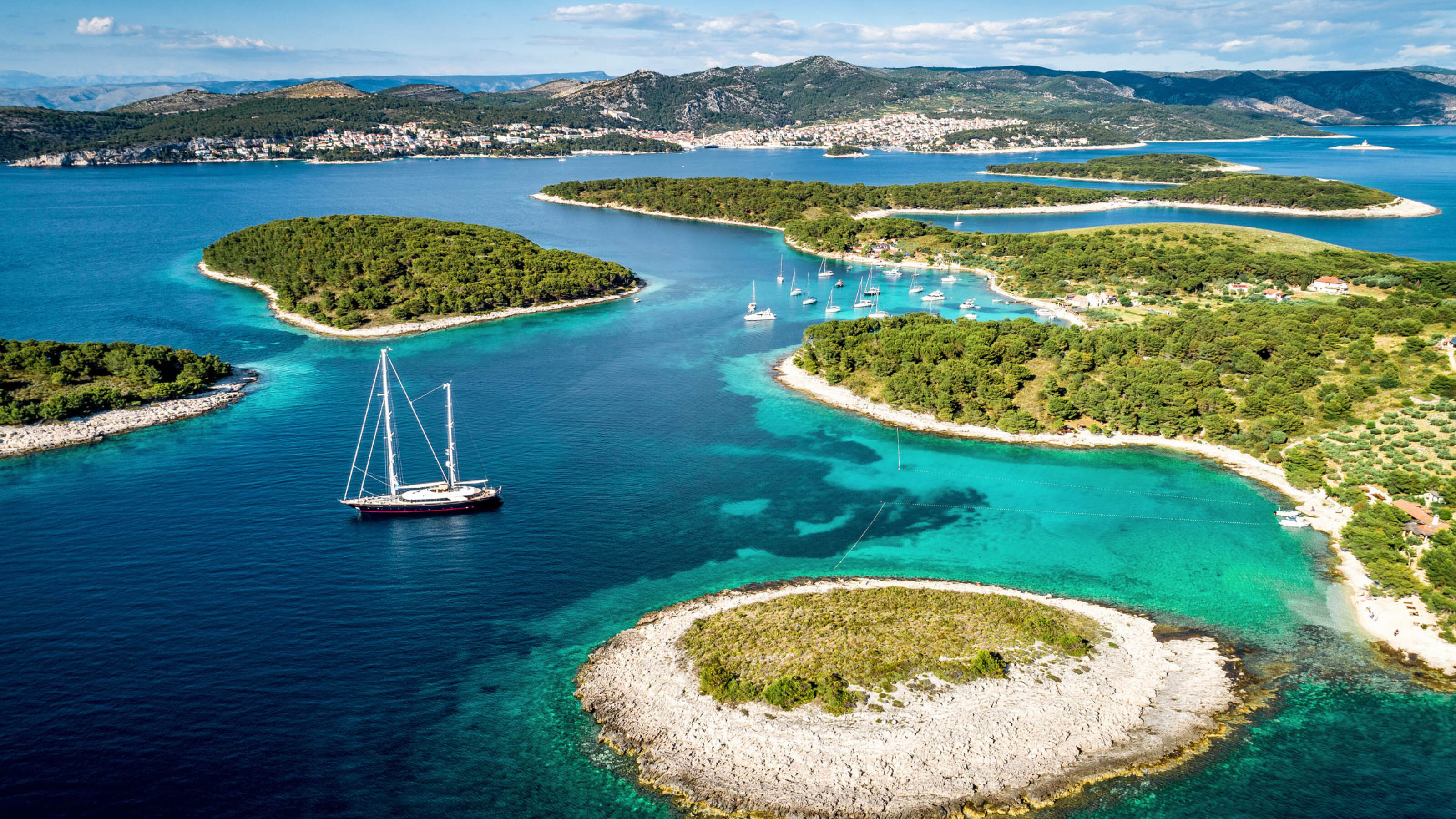 Aerial view of Paklinski Islands in Hvar, Croatia. Turquise water bays with luxury yachts and sailing boats.