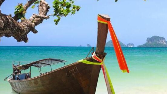 Tropical beach in Thailand and traditional long tail boat