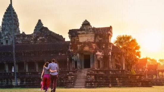 A couple in Angkor Wat at sunrise moment, Siem Reap, Cambodia