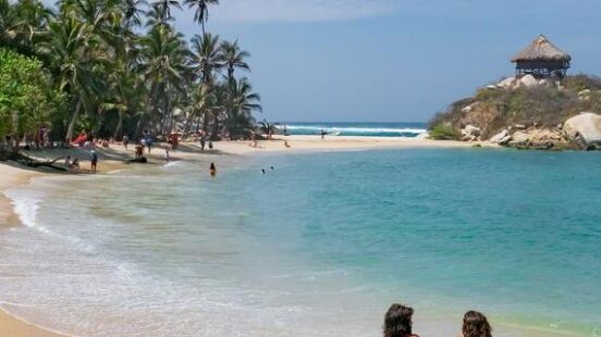 A couple sitting by the sea in Colombia, Tayrona