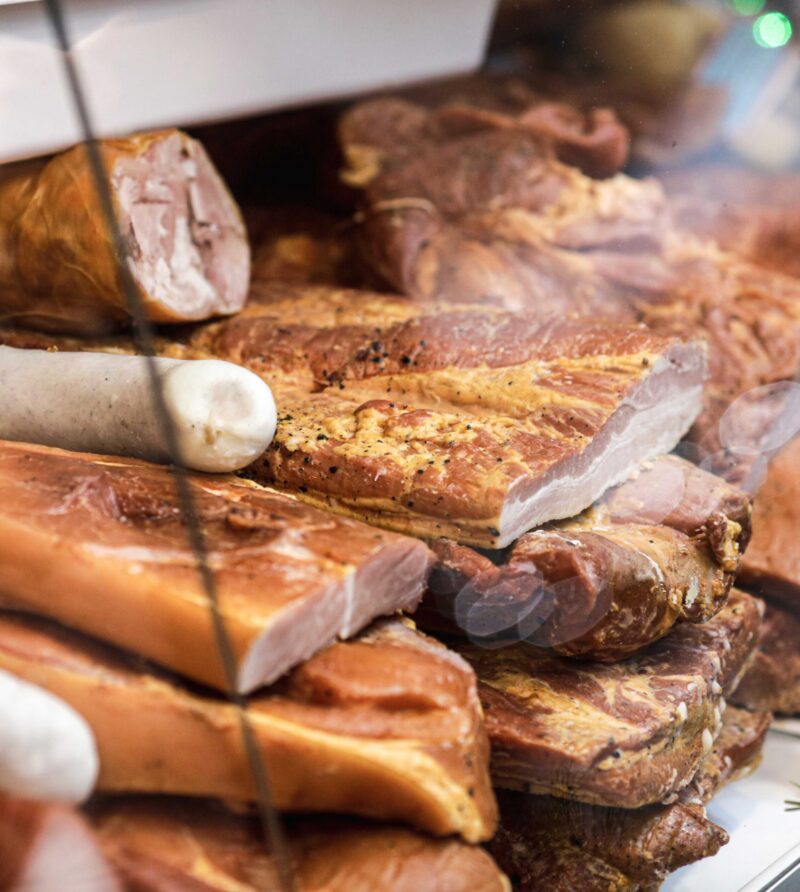 Shallow depth of field (selective focus) image with traditional Romanian winter holidays meat foods for sale in an outdoors market in Bucharest, Romania.