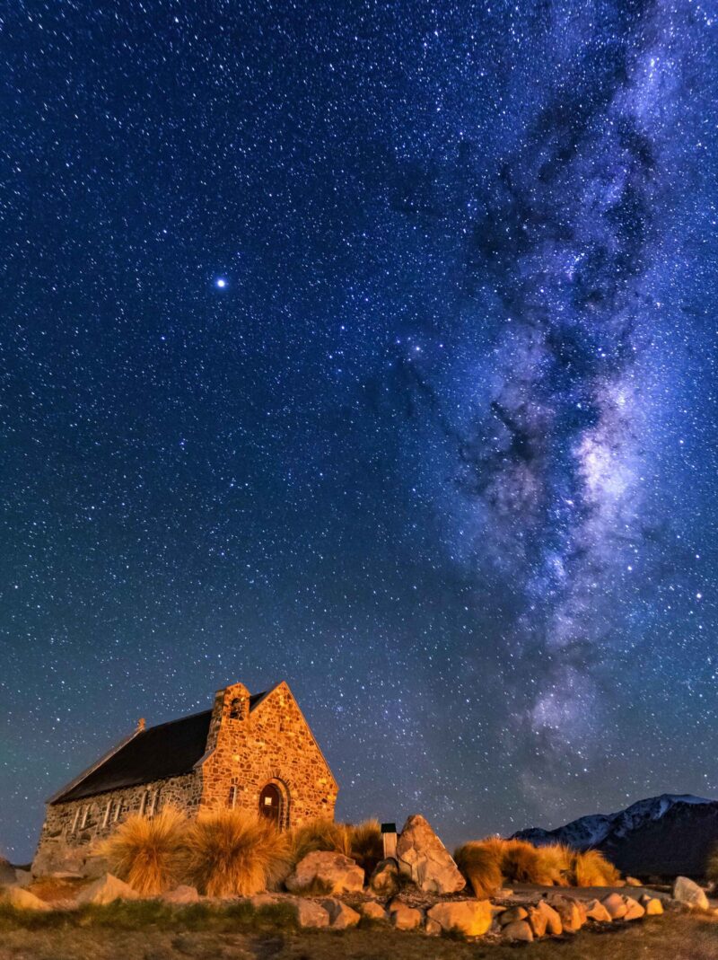 Milky Way Rising Above Church Of Good Shepherd, Tekapo NZ with Aurora Australis Or The Southern Light Lighting Up The Sky . Noise due to high ISO; soft focus / shallow DOF due to wide aperture used.