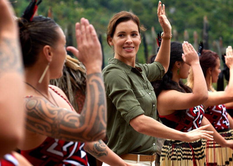 new zealand woman dancing with maori tribe.