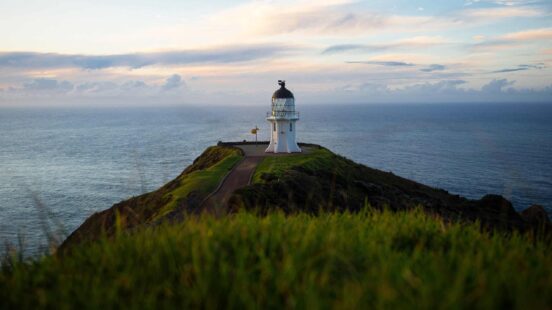 Panoramic view of historic white lighthouse on a clifftop atape Reinga Aupouri Peninsula