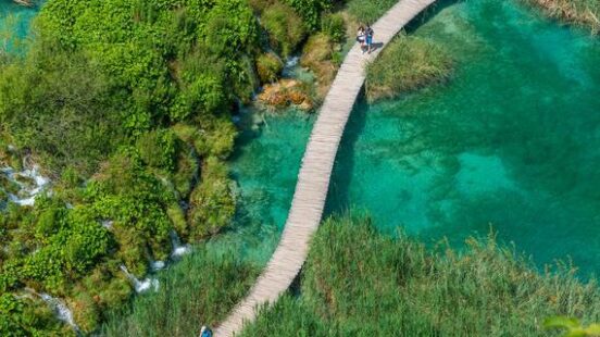 Aerial view of a wooden boardwalk leading through plitvice lakes national park in Croatia