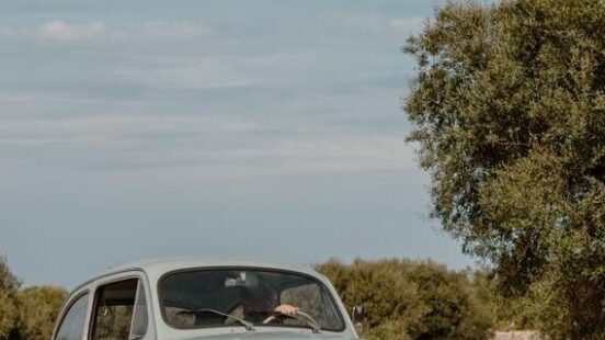 A vintage light blue car parked on a dirt road in the countryside on luxury Puglia tours.