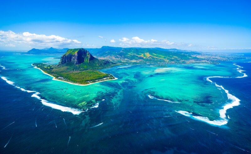 Aerial view of Mauritius island aerial, brabant, cloudy, cloud, coast, coral, day, destination, famous, heritage, hill, indian ocean, island, lagoon, landscape, le morne, mauritian, mauritius, morne, mountain, natural, nature, ocean, panoramic, panorama, paradise, peninsula, place, reef, rock, landmark, scene, scenery, scenic, sea, sky, summer, tourism, touristic, travel, tropical, underwater, view, wallpaper, waterfall, world, africa, top, air, green, palm, beach, sand, sandy, bay Aerial view of Mauritius island panorama and famous Le Morne Brabant mountain, beautiful blue lagoon and underwater waterfall
