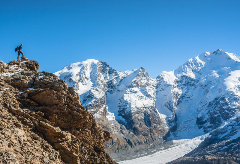 Hikers on mountain peak in Switzerland.