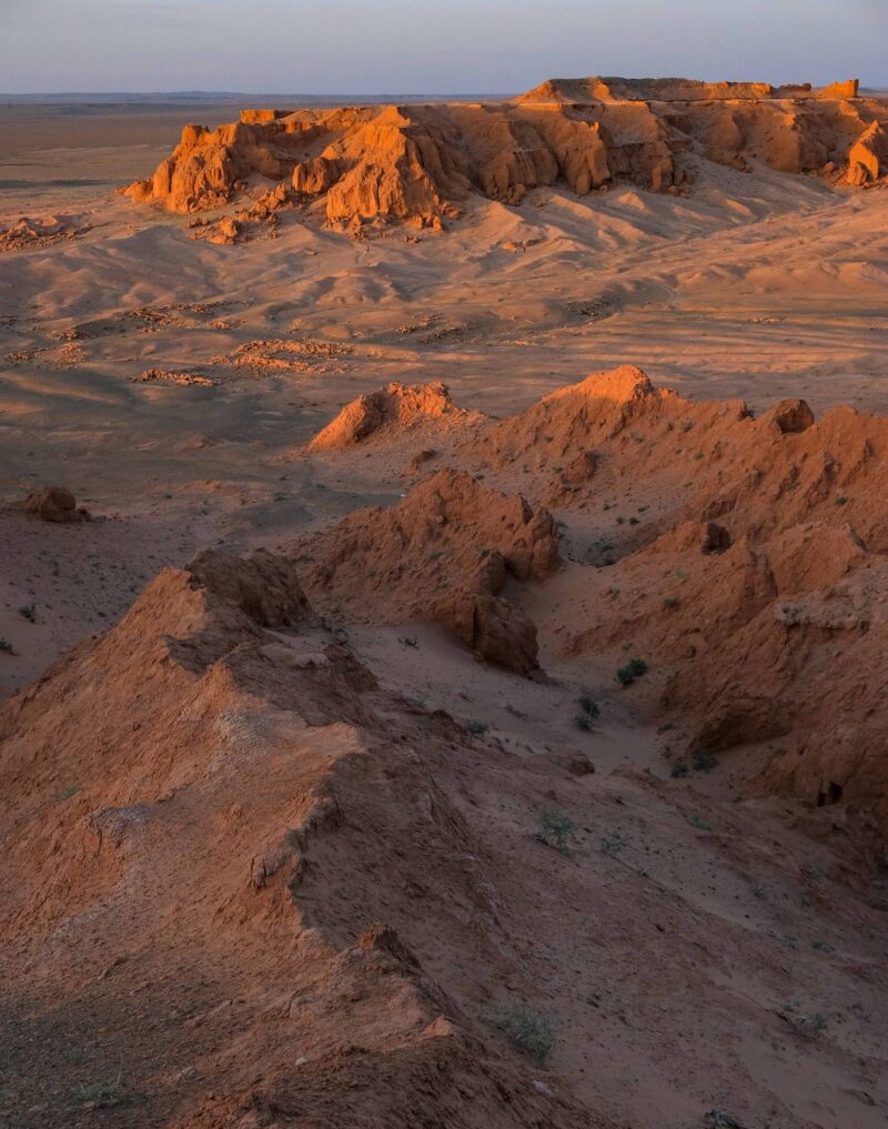 Red rock formations glowing at sunset, a scenic destination on luxury Mongolia vacations.