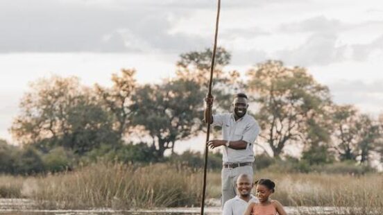 A family in a mokoro at Wilderness Vumbura Plains, Botswana