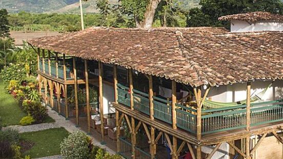 Hacienda Bambusa in Colombia, a luxurious hotel with a verandah and green balcony railings