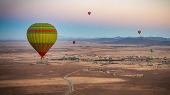 Hot air balloons float above Marrakech, Morocco,