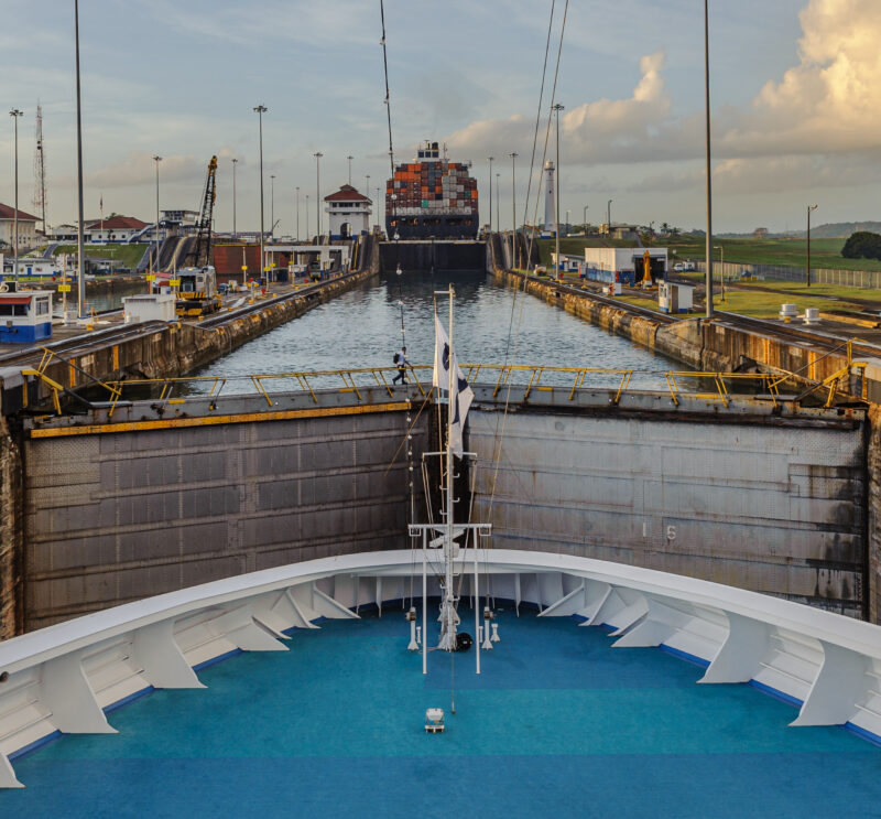 View from the bow of a ship navigating the Miraflores Locks on the Panama Canal.