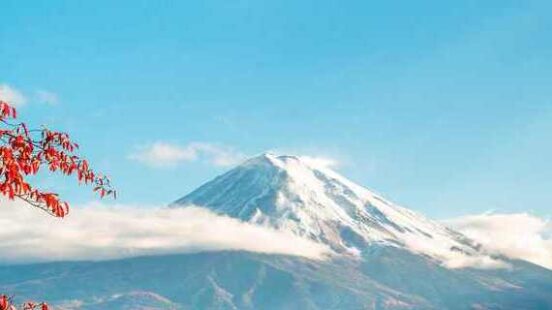 Mount Fuji surrounded by autumn leaves in Japan