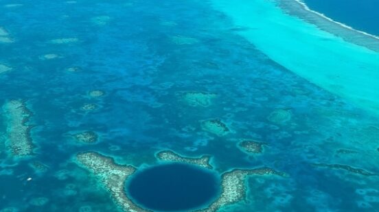 Aerial view of the Great Blue Hole – deep navy marine sinkhole off Belizex27;s coast.