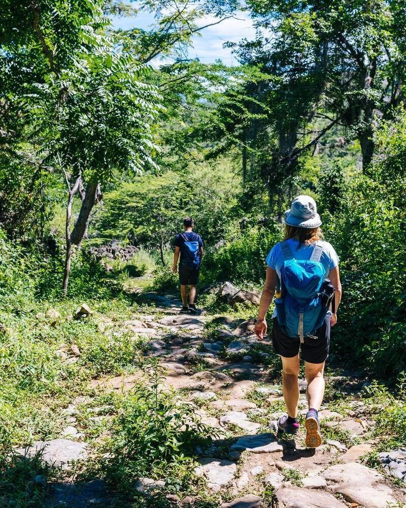 Two hikers on the ancient stone paved road from Barichara to Guane called "El Camino Real". , Barichara/ Colombia/ South America