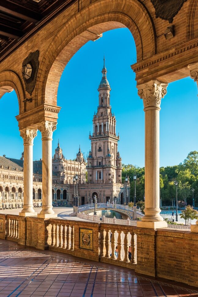 SEVILLE, ES – JULY 28, 2017: Plaza de Espana is an architectural ensemble located in the Maria Luisa Park in Seville, Spain. It was built as the main building of the Ibero-American Exposition of 1929. www.anibaltrejo.com