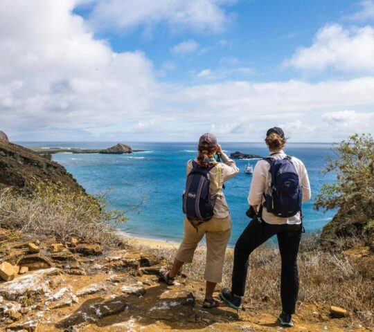 Hikers looking out to crystal blue waters