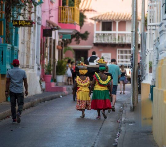 Fruit sellers and travellers through Cartagena's brightly coloured streets