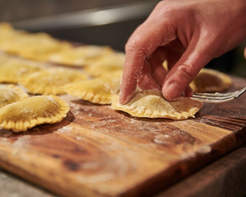 Making italian ravioli. Preparing traditional italian food. Preparing traditional italian ravioli. Making homemade ravioli. flour, kitchen, parmesan, pasta dough, culinary, mediterranean, wheat, noodles, italy, preparation, selfmade, traditional, vegetarian, dish, italian, ravioli, italian cuisine, stuffing, tortellini, italian culture, italian food, gourmet, pasta, lunch, making, raw, recipe, savory food, spinach, ricotta, food, cooking, hand, fresh, closeup, cook, homemade, wooden, healthy, cuisine, table, meal, ingredient, chef, dough, organic, delicious, board, dinner, rustic Pasta-making, Italy