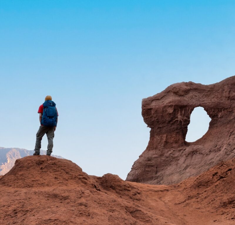 Hiker with backpack enjoy the landscape on deserted mountains - The Window in the Rock (Las Ventanas in spanish) in Cafayate, Salta, Argentina