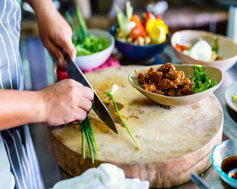 Chef making traditional cambodian meat dish at cooking class