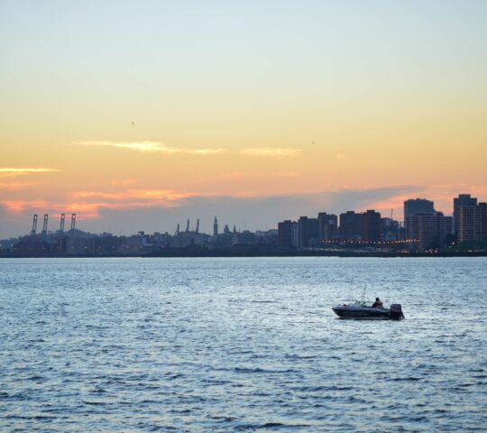 Sail across the Rio de la Plata as the sun sets