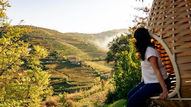 Woman looks out to Portuguese vineyards in Douro Valley
