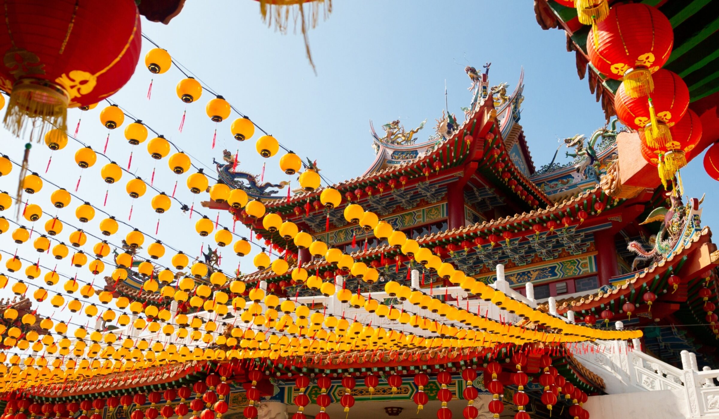 Red and yellow lanterns decorate the ornate Thean Hou Temple roof during luxury Malaysia tours.