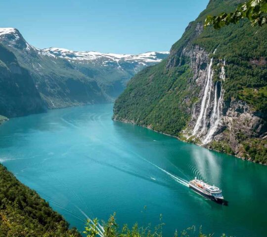 A boat cruises the stunning Norwegian fjords