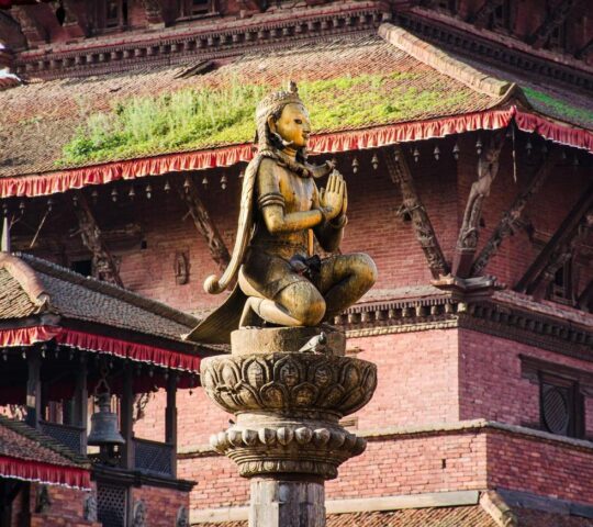 A statue of a Malla king in Patan Durbar Square