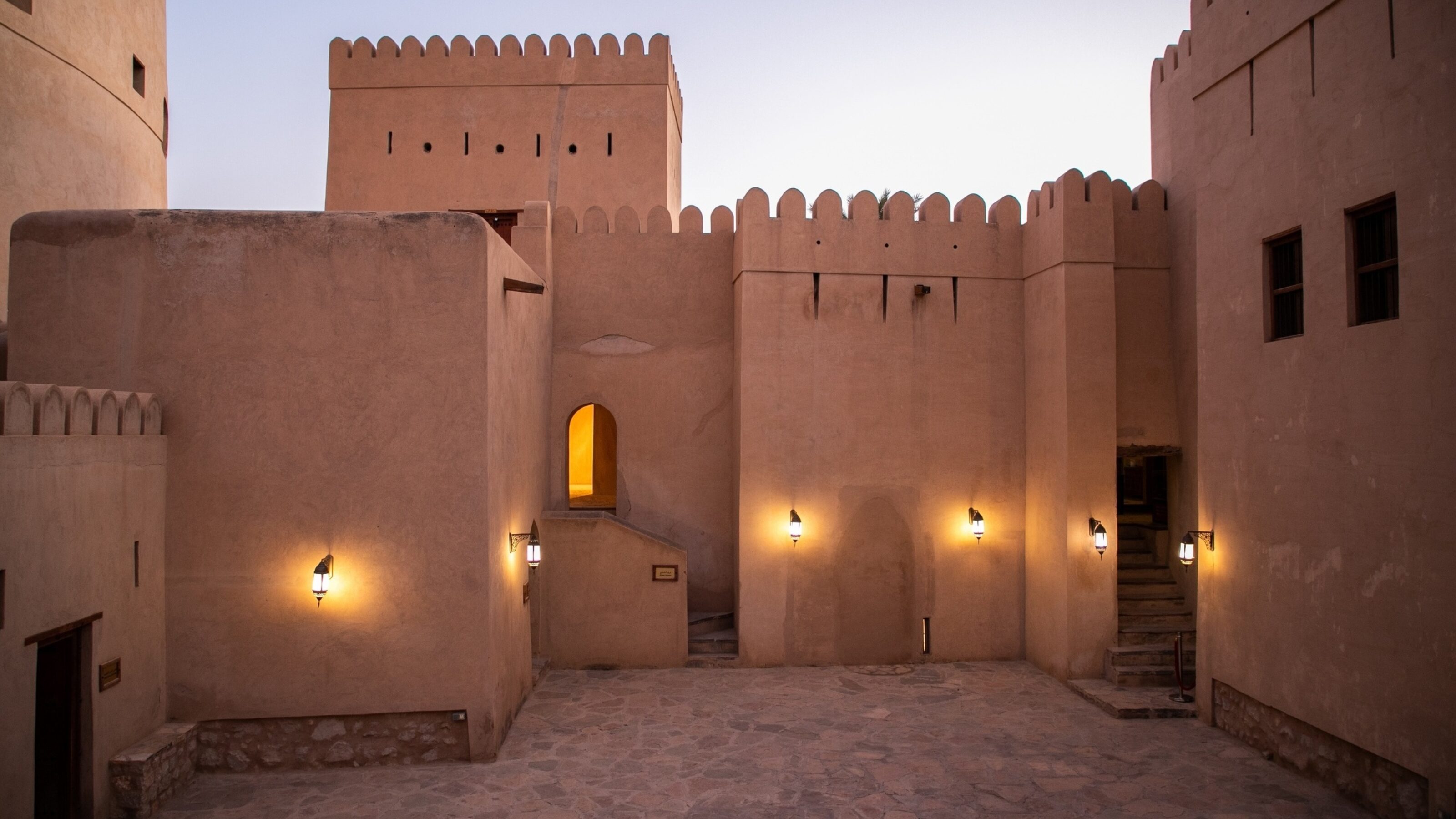 Nizwa fort lit up at nightfall
