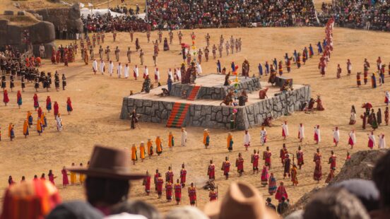 A vibrant outdoor cultural festival with performers in traditional costumes.