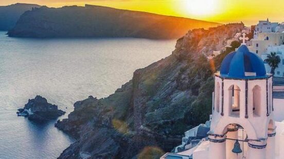 Beautiful view of Churches in Oia village, Santorini, Greece at sunset