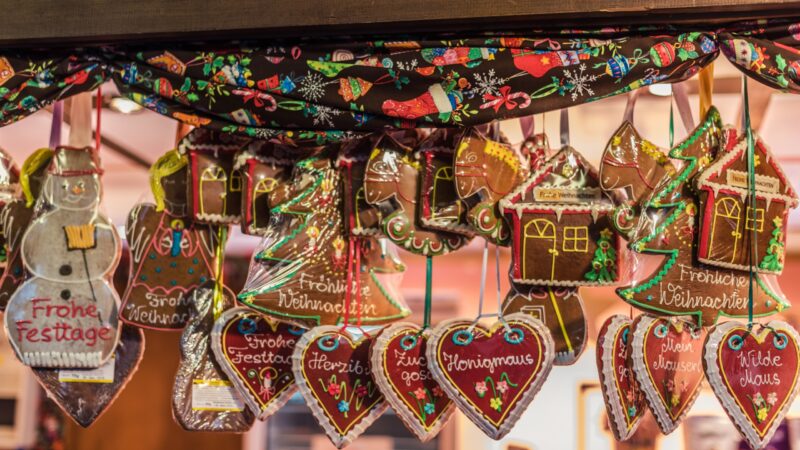 Vienna, Austria - December 24, 2017. Traditional gingerbread hearts, houses, snowman and angel at Viennese Christmas Market. Close view of Xmas fair kiosk selling sweets.