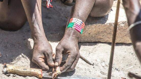 Hadzabe men making fire
