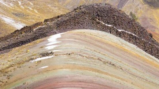 Hikers on the colorful slopes of Rainbow Mountain, Peru.