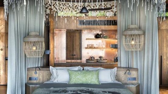 Rustic-styled bedroom with a unique shell chandelier, wooden accents, and neutral tones.
