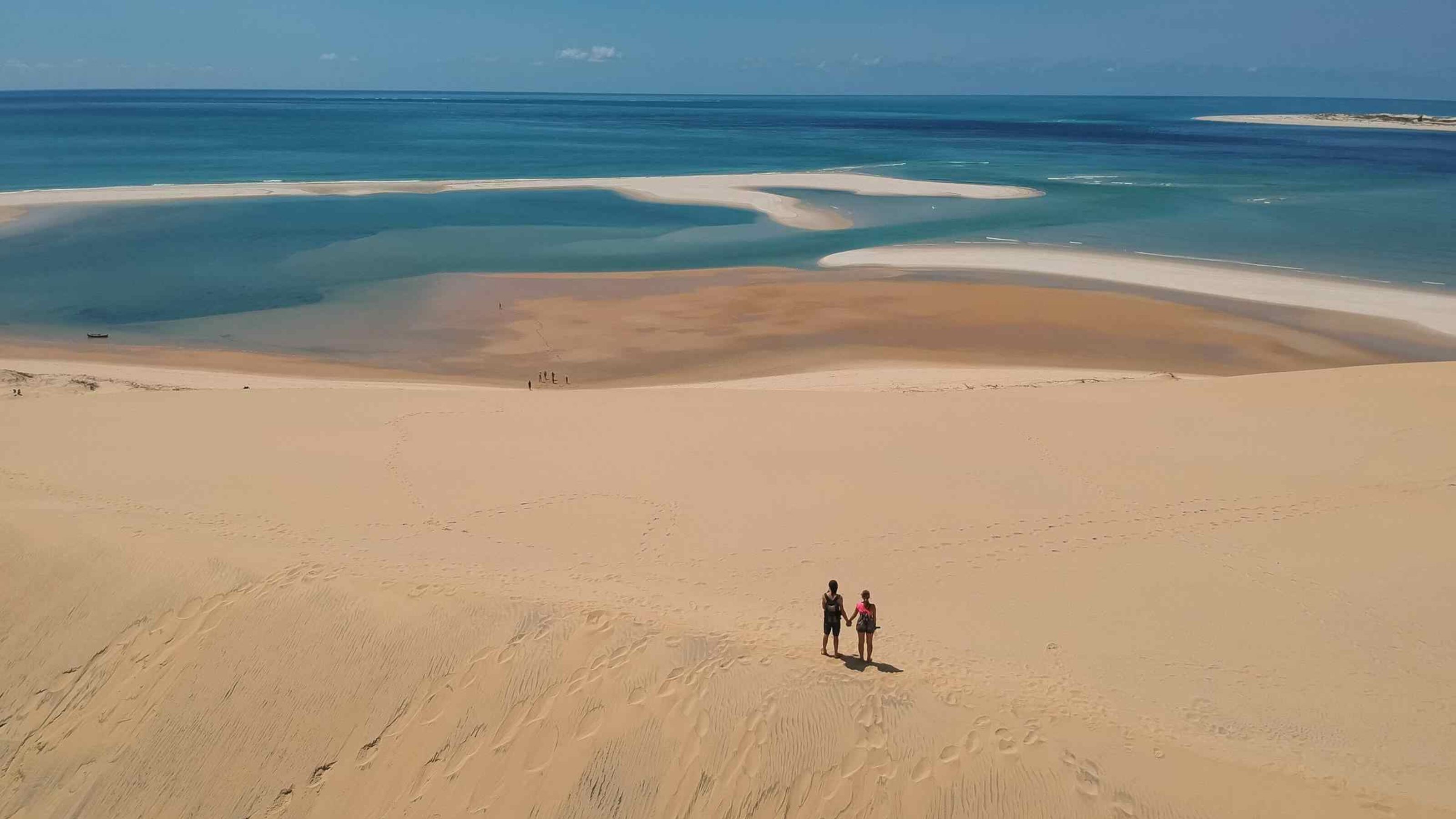 A couple holding hands on a beach in the Bazaruto Archipelago