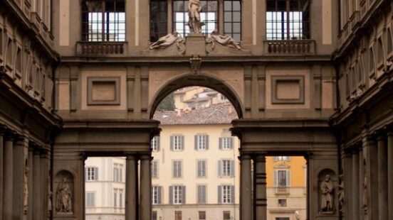 A view through an ornate archway in a European classical building.