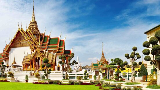 Traditional Thai temple complex with ornate buildings and manicured gardens.