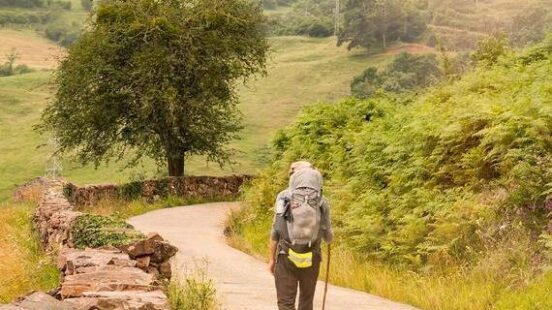 hiker with backpack walking the Camino de Santiago in Spain, Way of St James