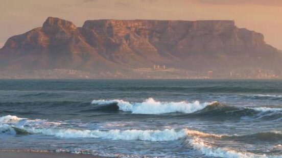 Sunset on the beach overlooking Table Mountain in Cape Town