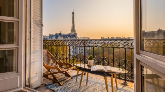 Balcony view of the Eiffel Tower at sunset
