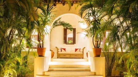 A pathway sheltered by palm trees at Esencia on the Riviera Maya